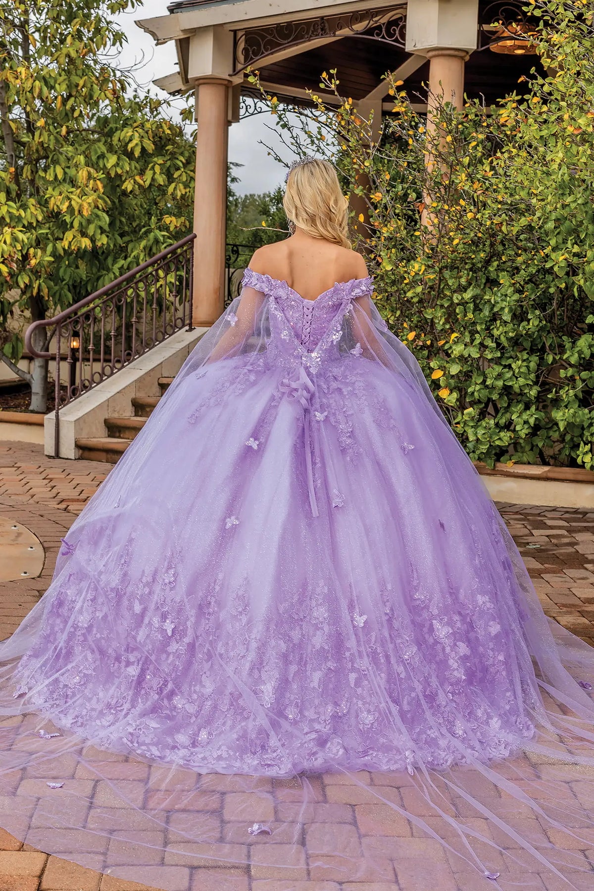 Back view of a Lilac quinceañera gown showing lace-up back, full tulle skirt, and floral embroidery