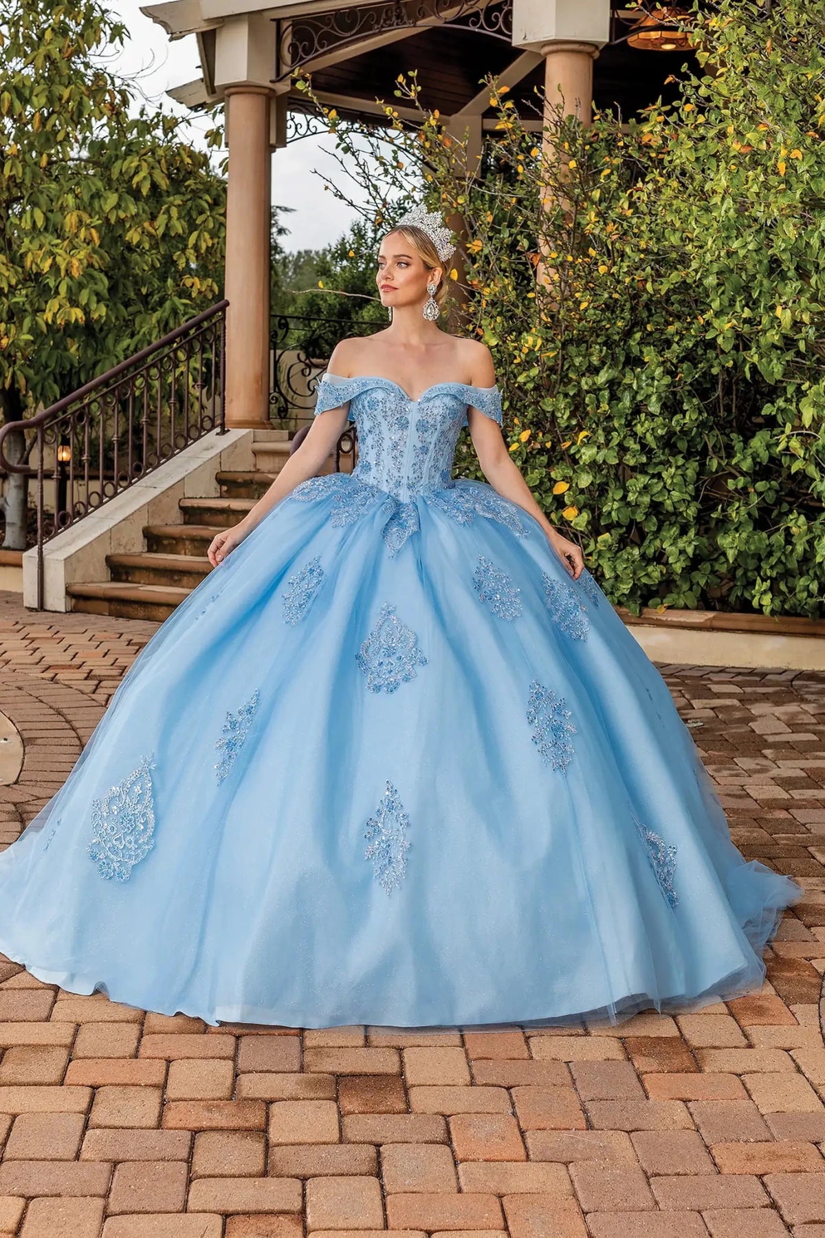 Front view of a Bahama Blue quinceañera gown with off-the-shoulder neckline, lace appliqués, and full tulle skirt