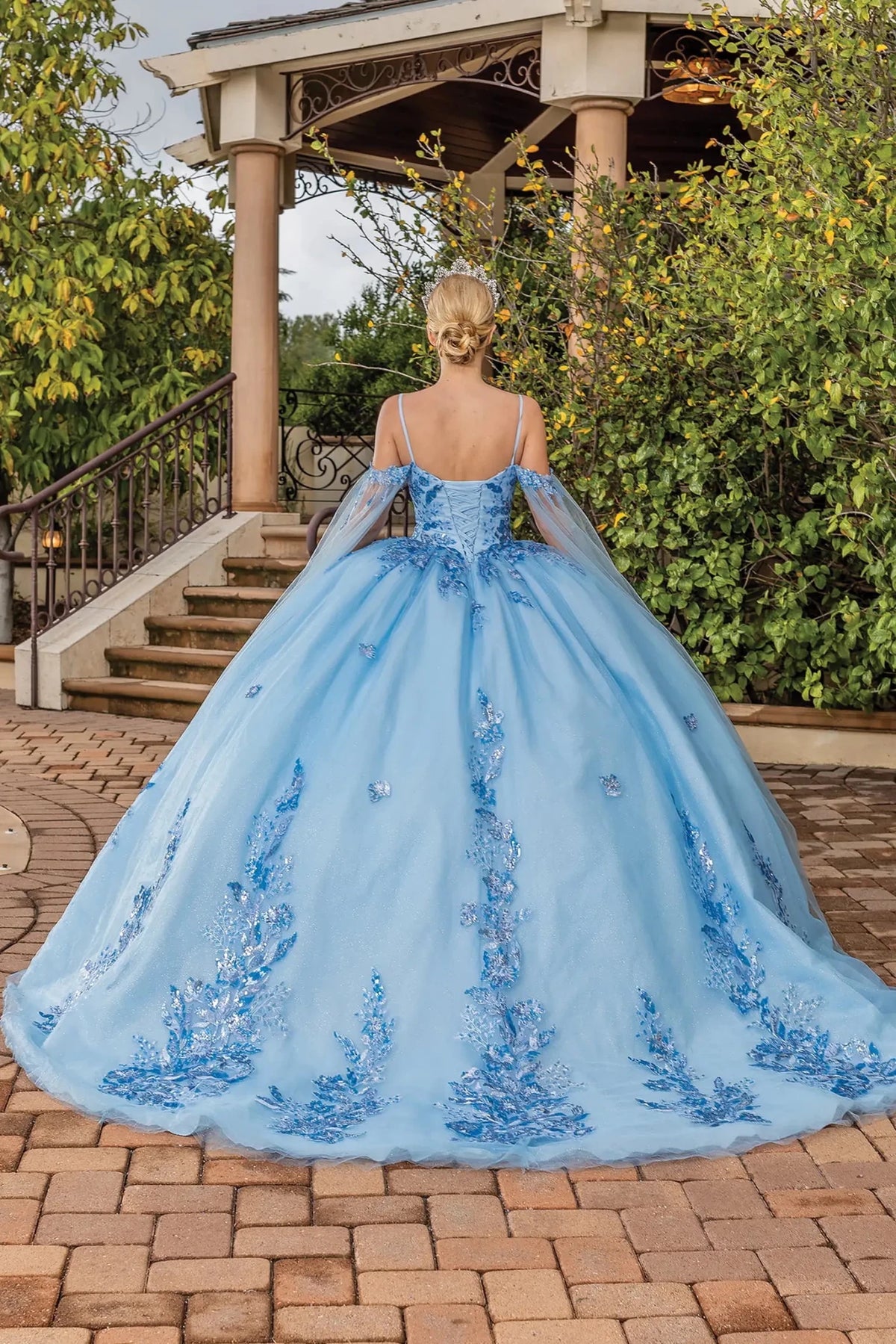 Back view of a Bahama Blue quinceañera gown showing lace-up back and tulle train