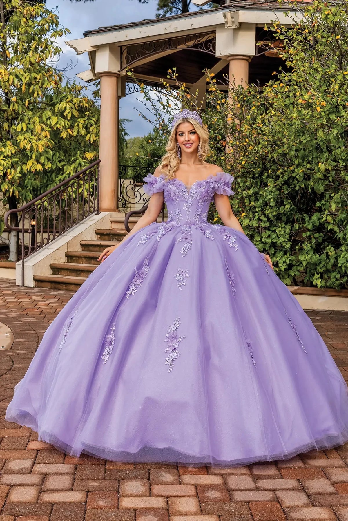 Front view of a Lilac quinceañera gown with off-the-shoulder neckline and embroidered appliqués