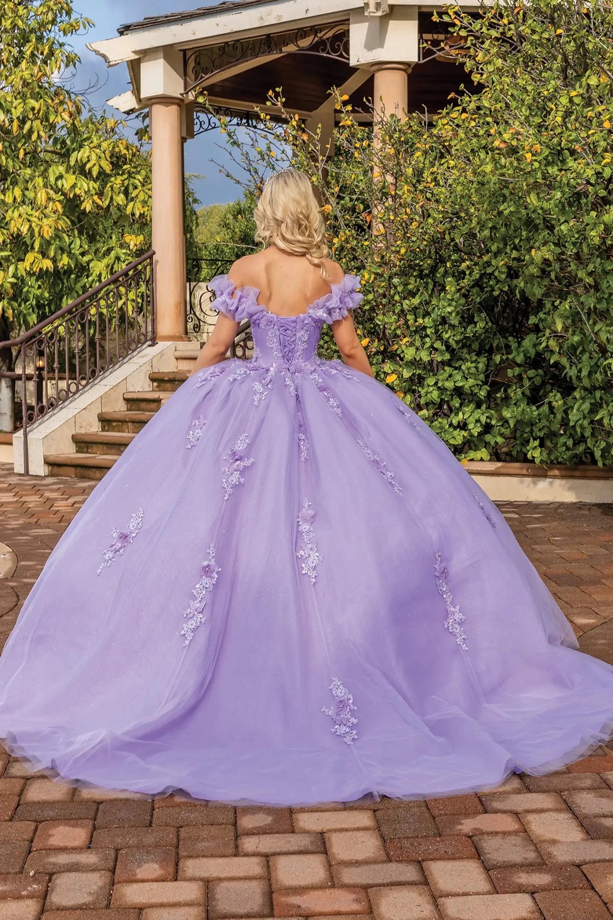 Back view of a Lilac quinceañera gown showing lace-up back and embroidered appliqués
