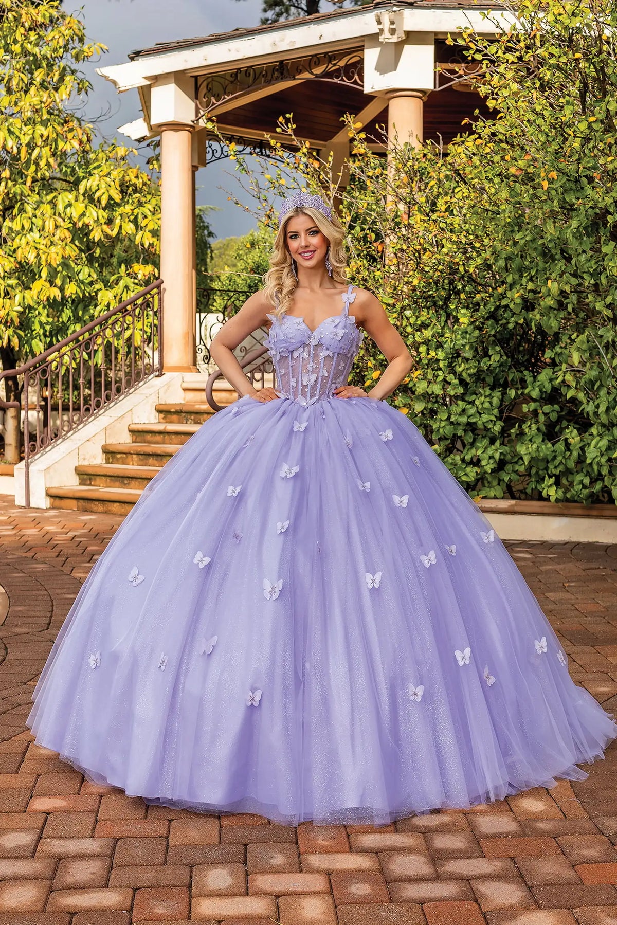 Front view of a Lilac quinceañera gown with corset bodice, floral appliqués, and voluminous full skirt