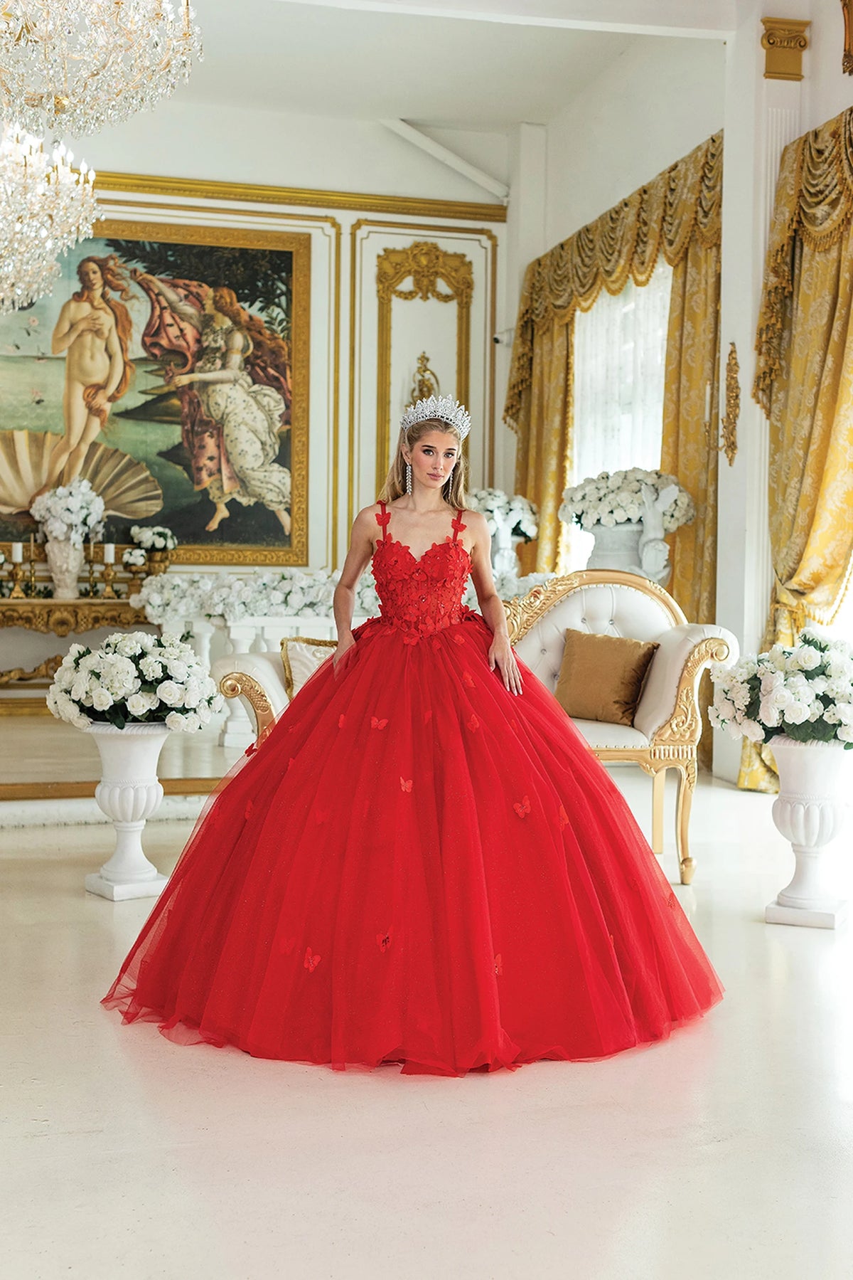 Front view of a Red quinceañera gown with corset bodice, floral appliqués, and voluminous full skirt