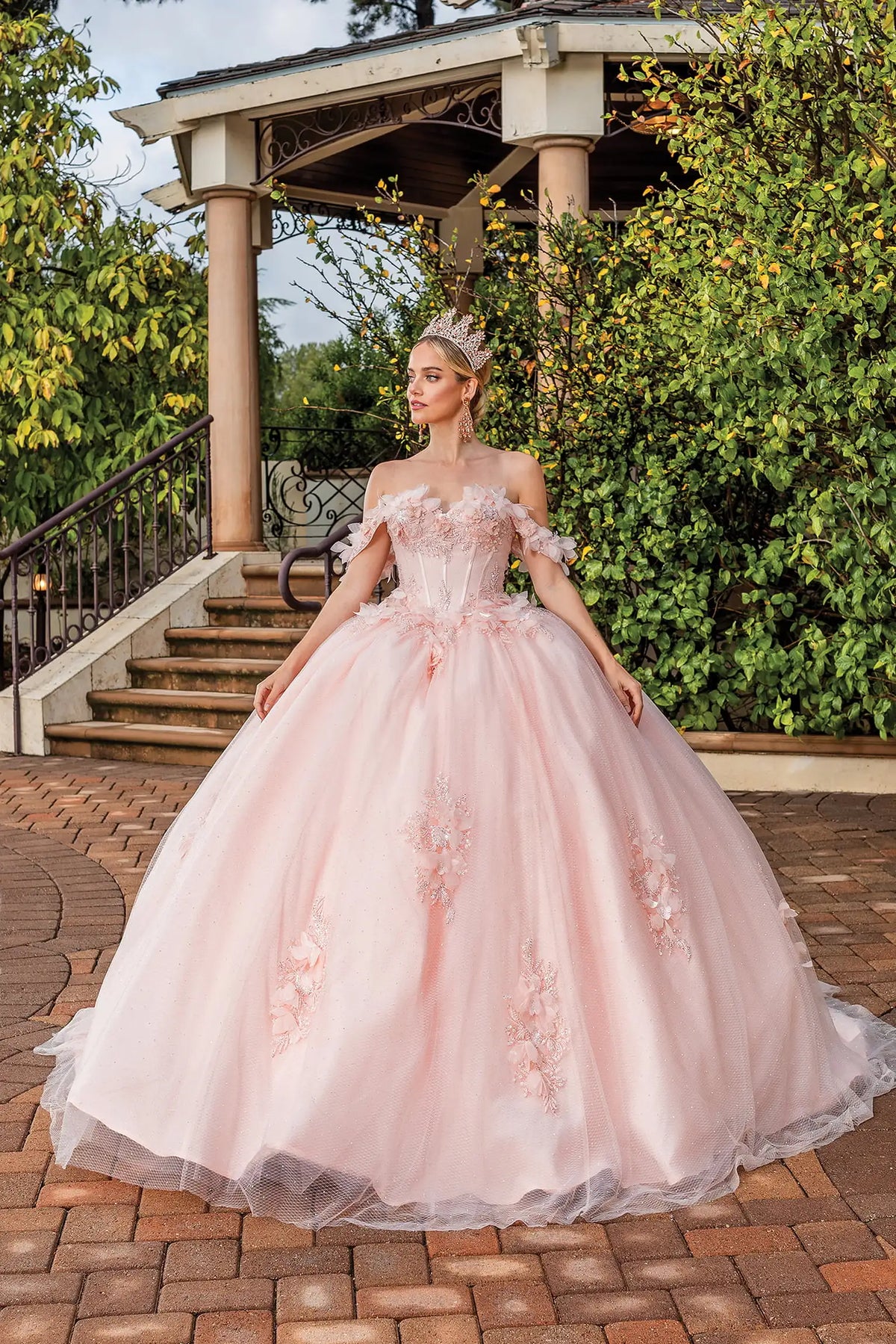Front view of a Blush quinceañera gown with off-the-shoulder neckline, beaded lace bodice, and floral appliqués
