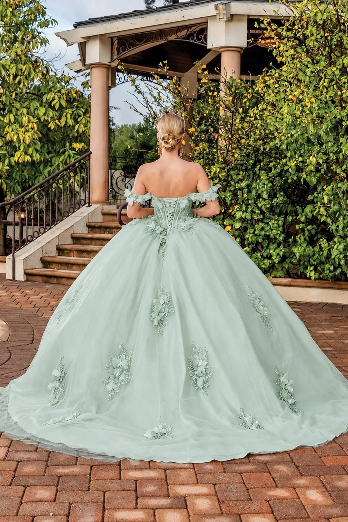 Back view of a Sage quinceañera gown showing lace-up back and floral appliqués
