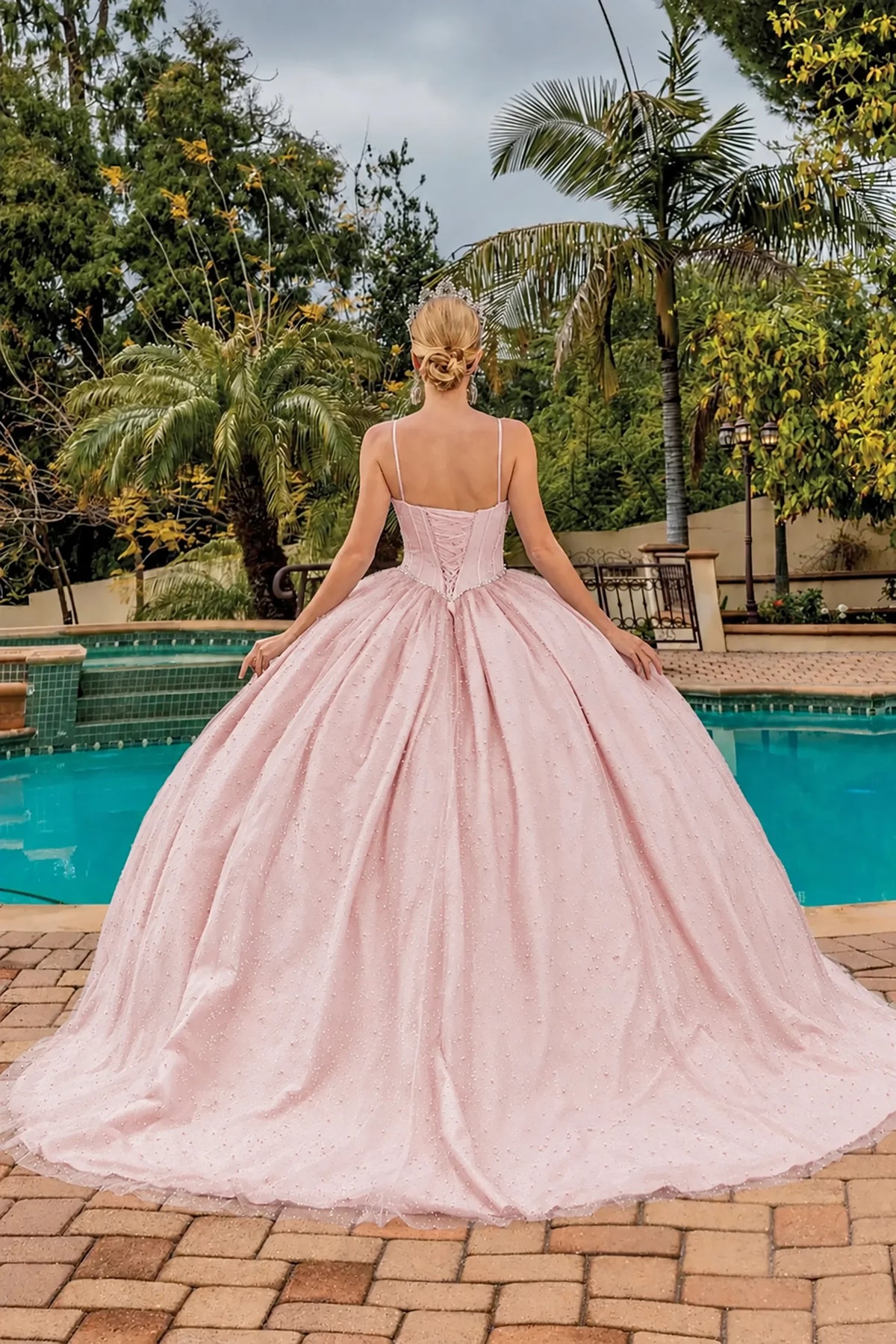 Back view of a Blush quinceañera gown showing lace-up back and glitter tulle skirt