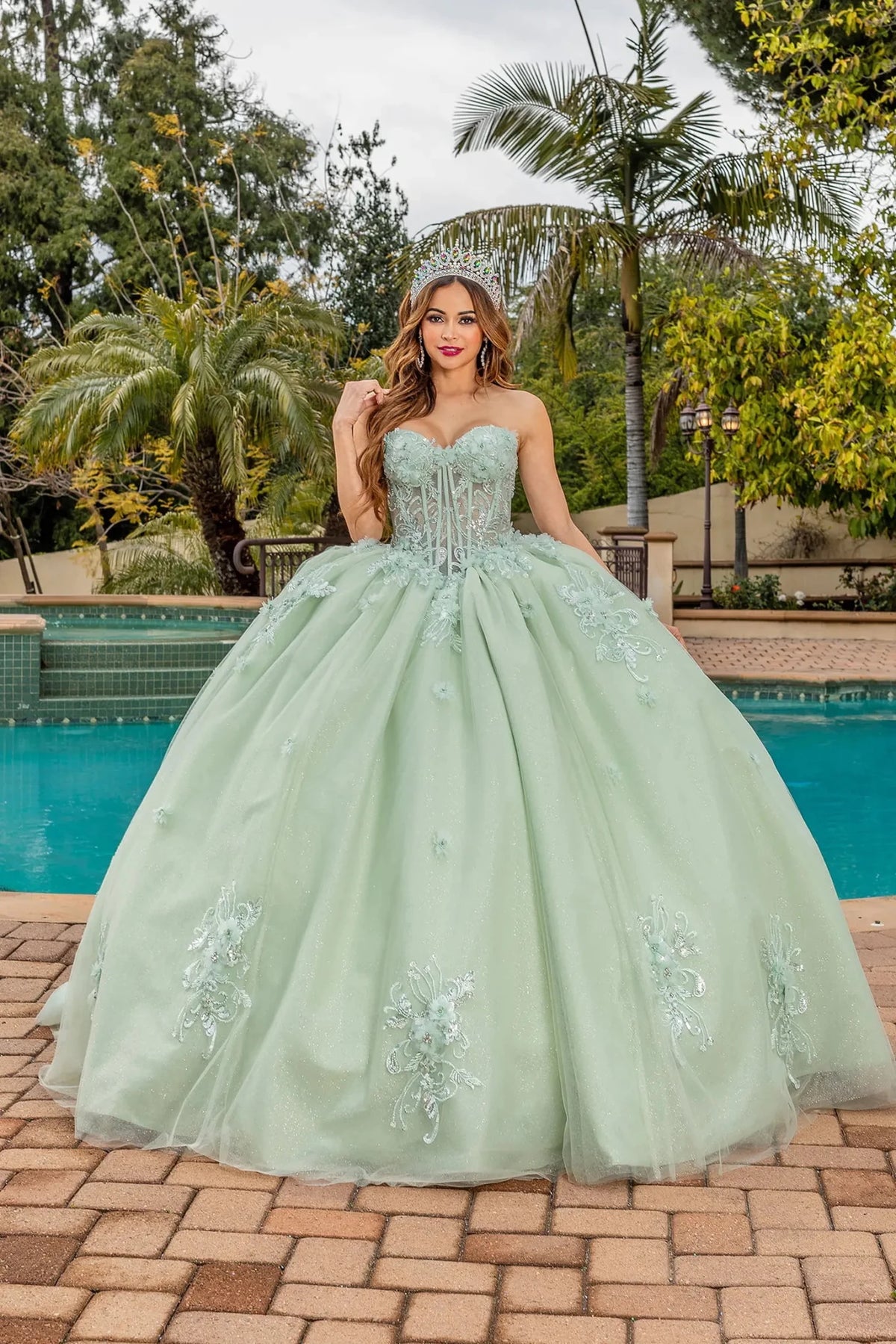 Front view of a Sage quinceañera gown with strapless neckline, beaded bodice, and embroidered appliqués
