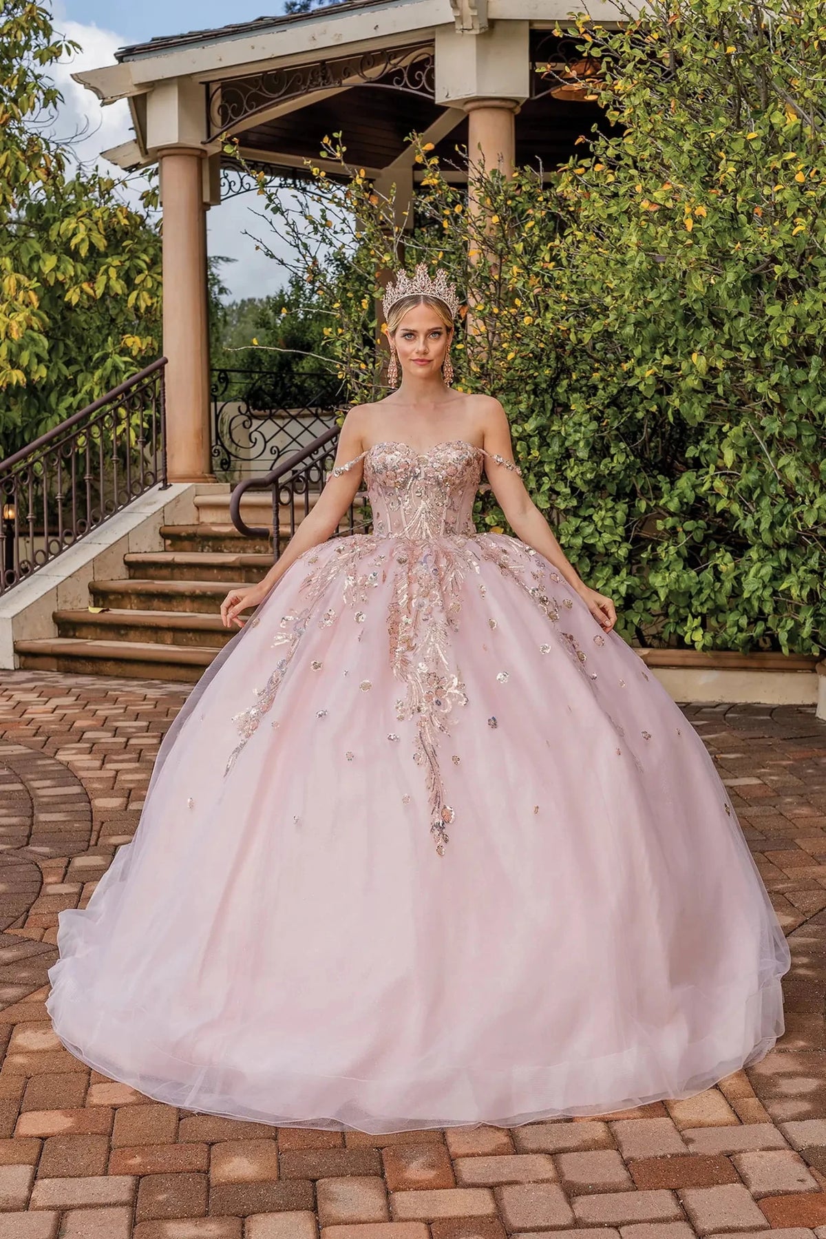 Front view of a Blush quinceañera gown with floral appliqués