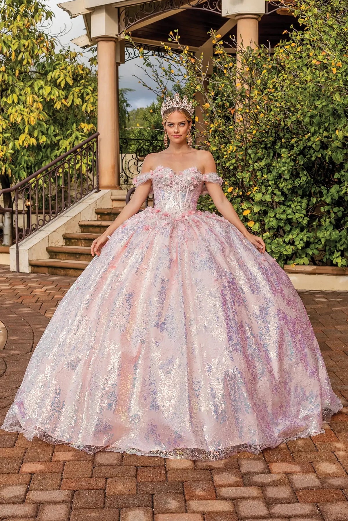 Front view of a Blush quinceañera gown with off-the-shoulder neckline, beaded bodice, lace appliqués, and glitter tulle skirt