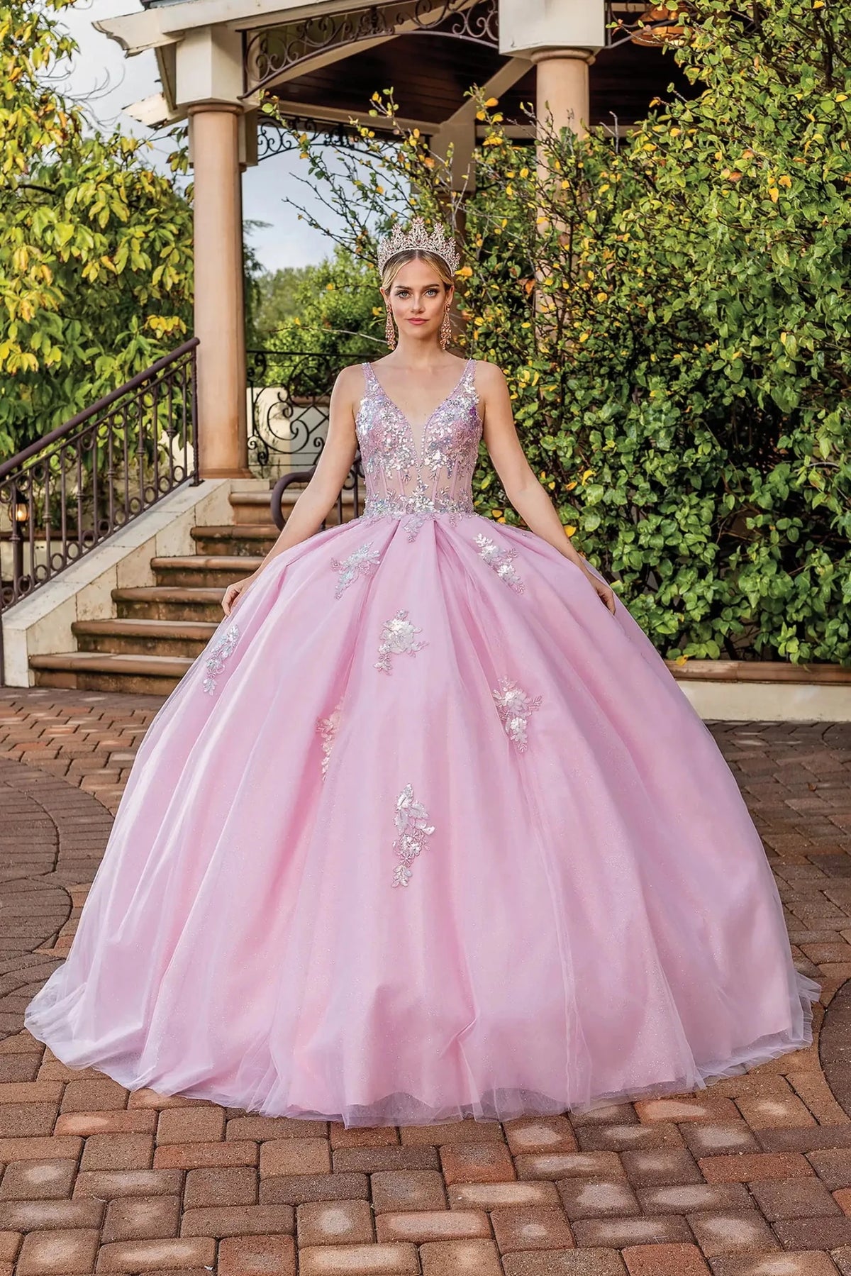 Front view of a Blush quinceañera gown with beaded bodice and floral appliqués
