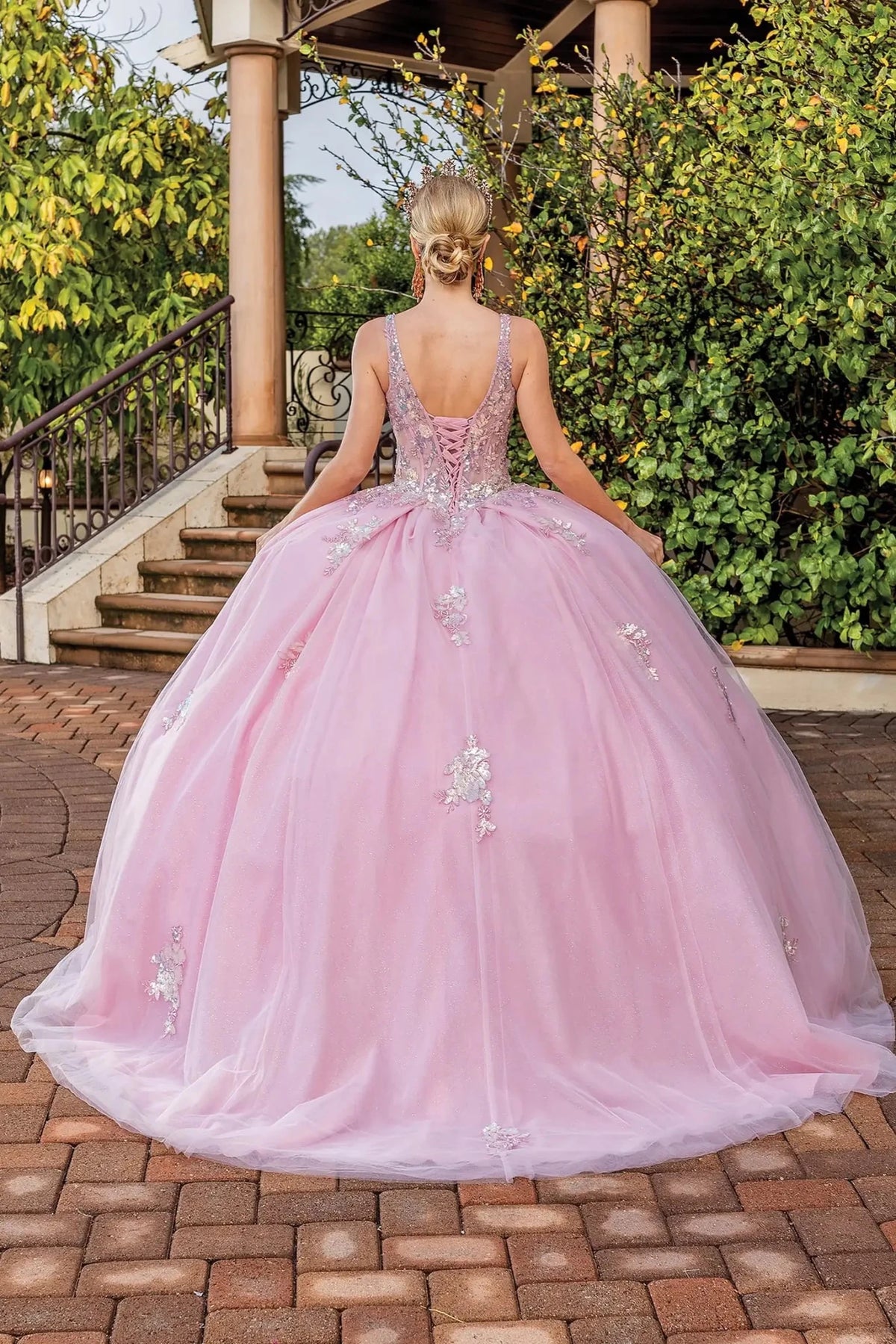 Full-length back view of a Blush quinceañera gown showing lace-up back and floral appliqués