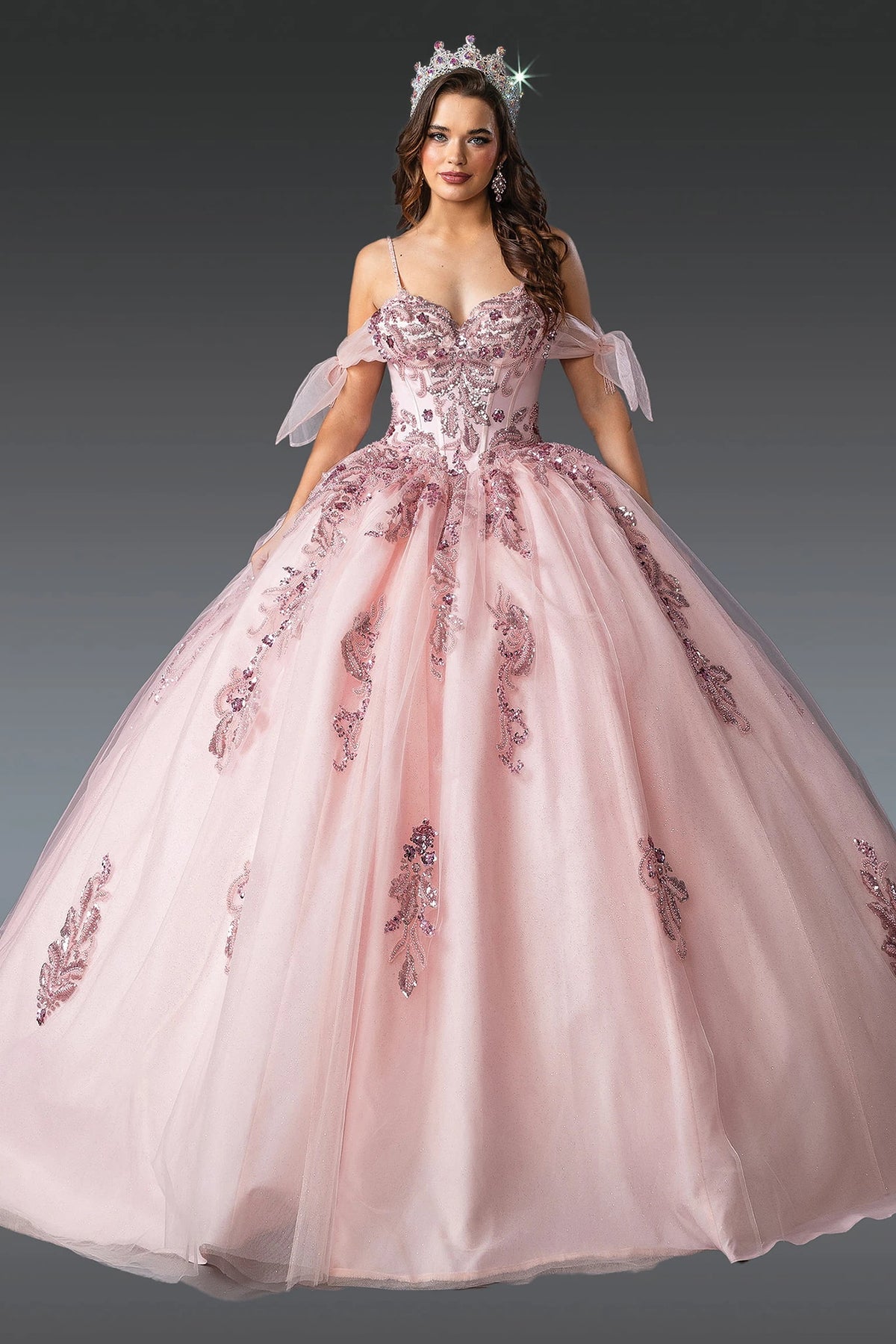 Front view of a Blush quinceañera gown with spaghetti straps, beaded bodice, and embroidered tulle skirt