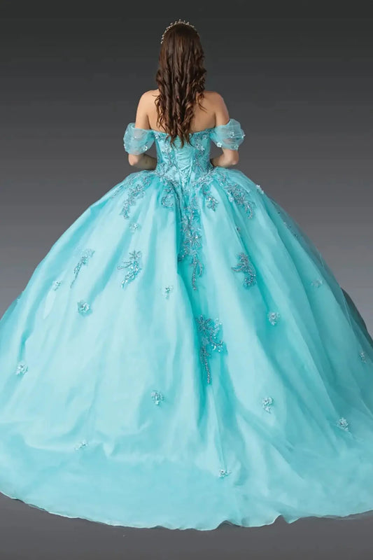 Back view of aqua quinceañera ball gown showcasing lace-up corset back, off-shoulder puff sleeves, embroidered tulle skirt, and full ball gown silhouette photographed in studio lighting