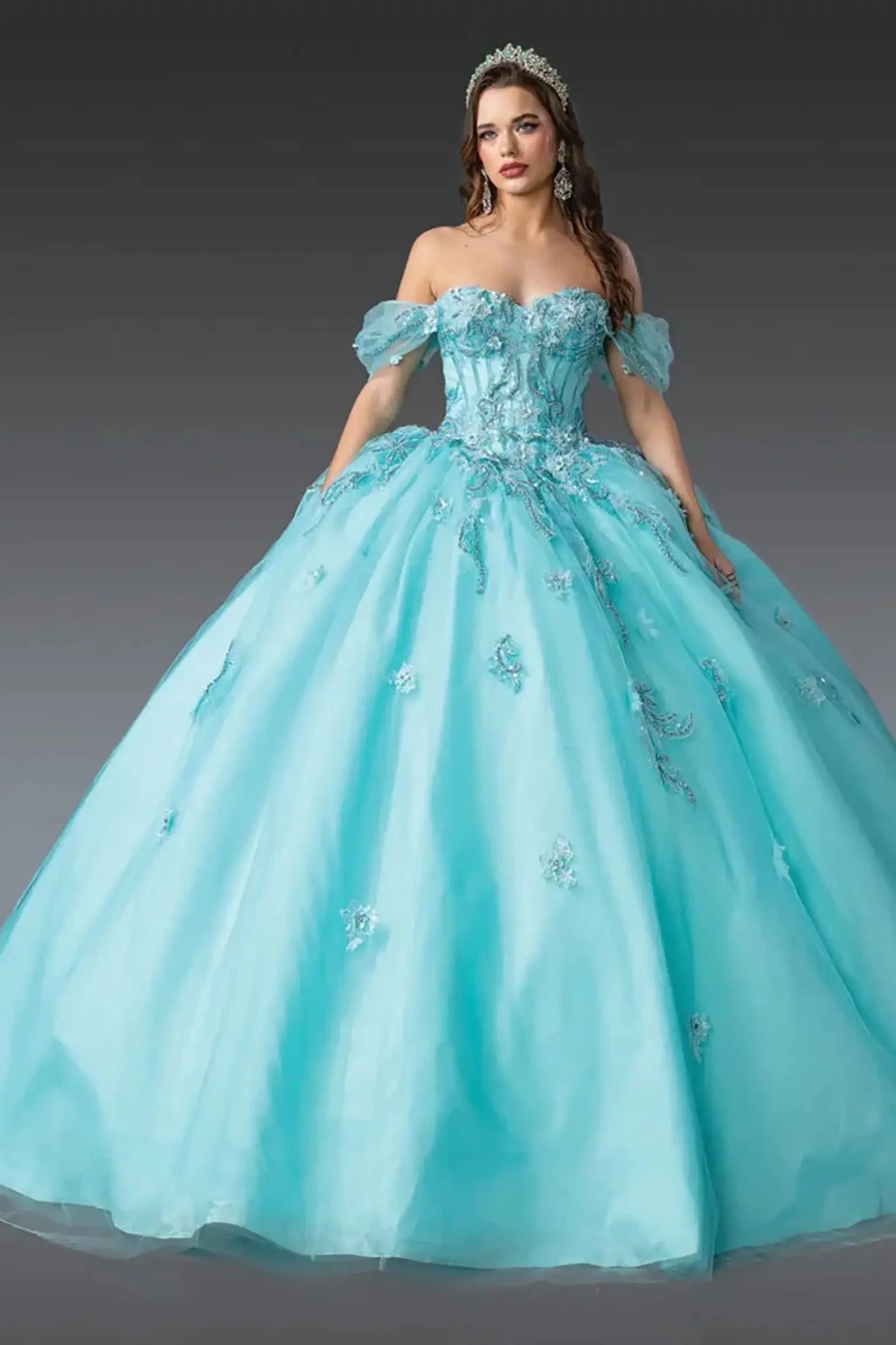 Front view of aqua quinceañera ball gown featuring off-shoulder corset bodice, puff tulle sleeves, intricate lace appliqués, voluminous layered tulle skirt, and tiara styling photographed in studio