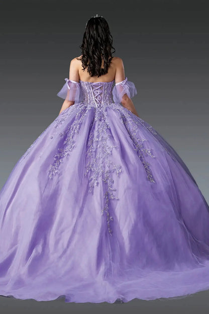 Back view of lilac quinceañera ball gown featuring lace-up corset back, off-shoulder tulle sleeves, floral appliqués, and voluminous tulle skirt