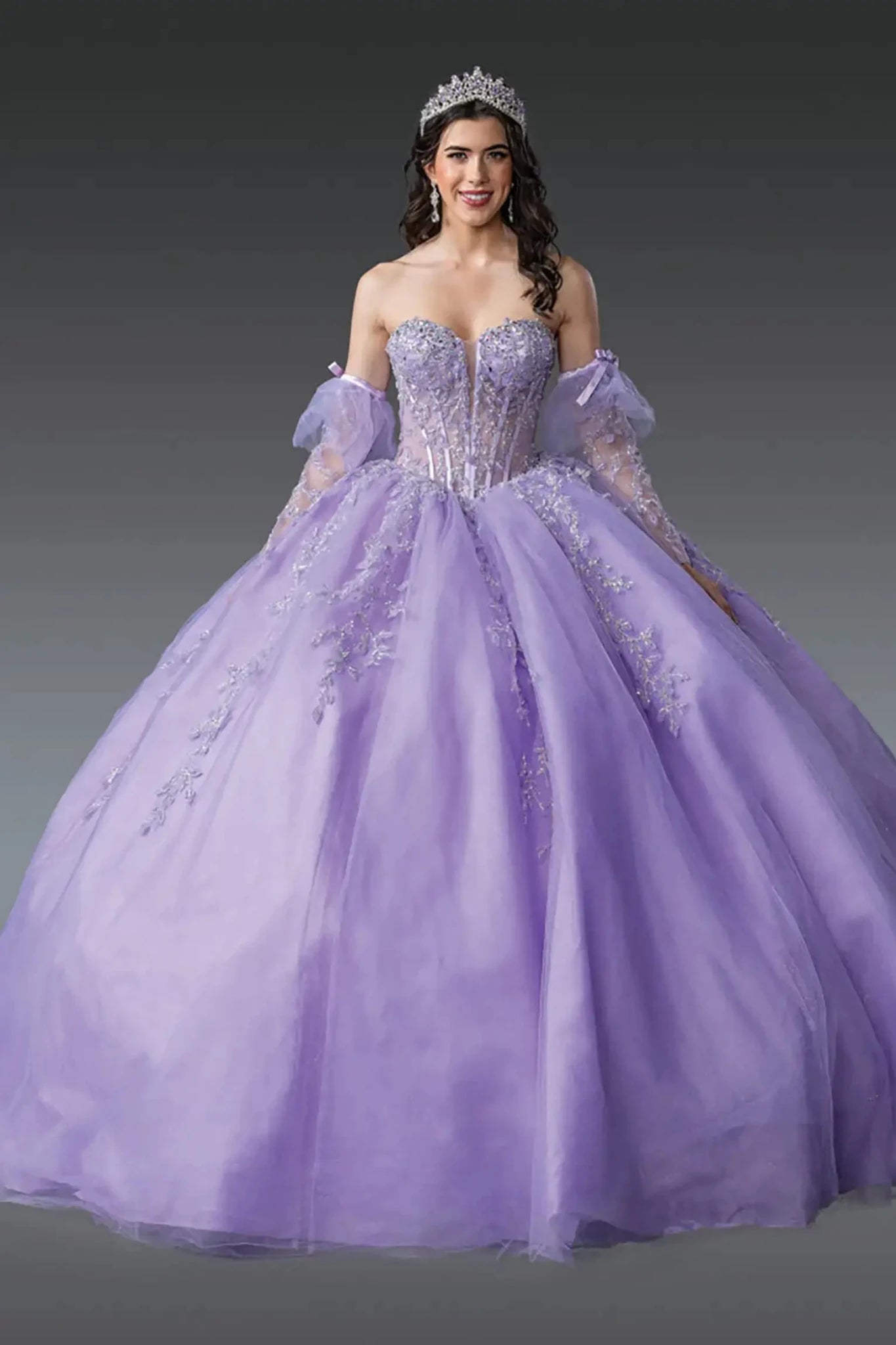 Front view of lilac quinceañera ball gown with sheer corset bodice, off-shoulder tulle sleeves, floral embroidery, and full layered tulle skirt