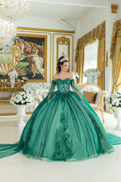 Woman standing front-facing in hunter green quinceañera ball gown with off-shoulder sleeves, beaded bodice, intricate embroidery, sheer cape details, floral accents, and voluminous tulle skirt