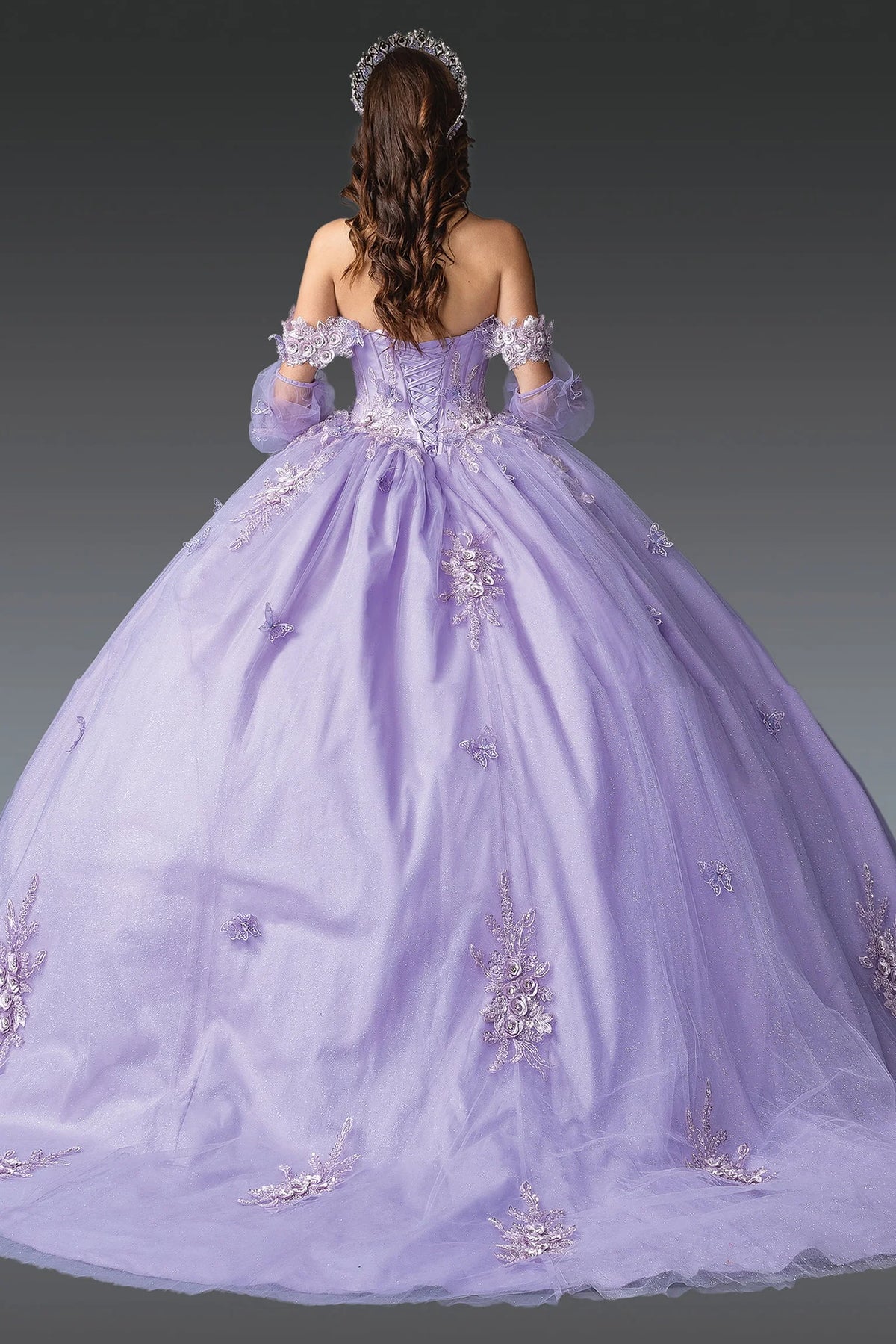 Back angle of a Lilac quinceañera gown showing lace-up back and floral appliqués