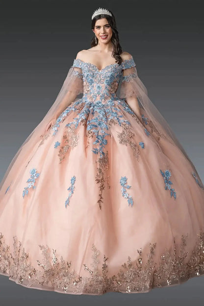 Front view of rose gold quinceañera ball gown featuring off-shoulder embroidered corset bodice, sheer tulle sleeves, blue floral appliqués, layered tulle skirt, and tiara styling photographed in studio
