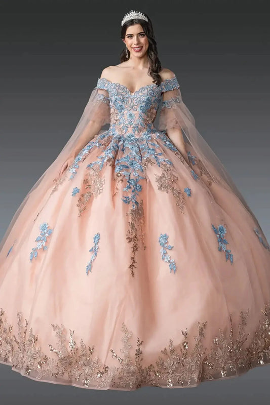 Front view of rose gold quinceañera ball gown featuring off-shoulder embroidered corset bodice, sheer tulle sleeves, blue floral appliqués, layered tulle skirt, and tiara styling photographed in studio