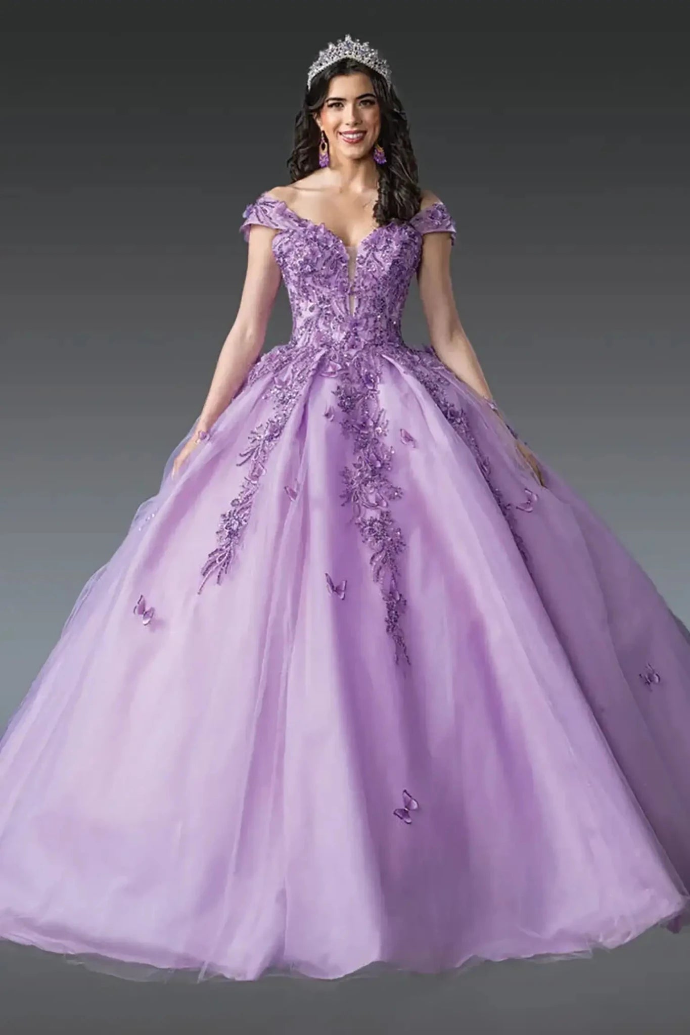 Front view of lilac off-shoulder quinceañera ball gown with corset bodice, deep V neckline, floral appliqués, butterfly accents, and full tulle skirt