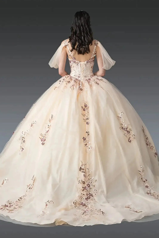 Back view: Champagne ball gown back featuring lace-up corset, sheer puff sleeves, and flowing tulle skirt with delicate floral embroidery.