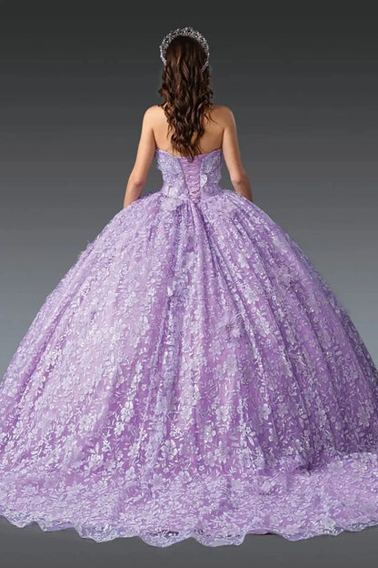Back view of lilac quinceañera ball gown showcasing lace-up corset back, all-over floral lace tulle skirt, dramatic fullness, and elegant ball gown silhouette photographed in studio lighting