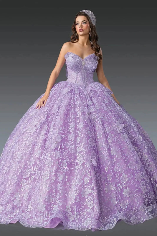 Front view of lilac quinceañera ball gown featuring strapless sweetheart corset bodice, full floral lace overlay, voluminous ball gown skirt, and tiara styling photographed in studio