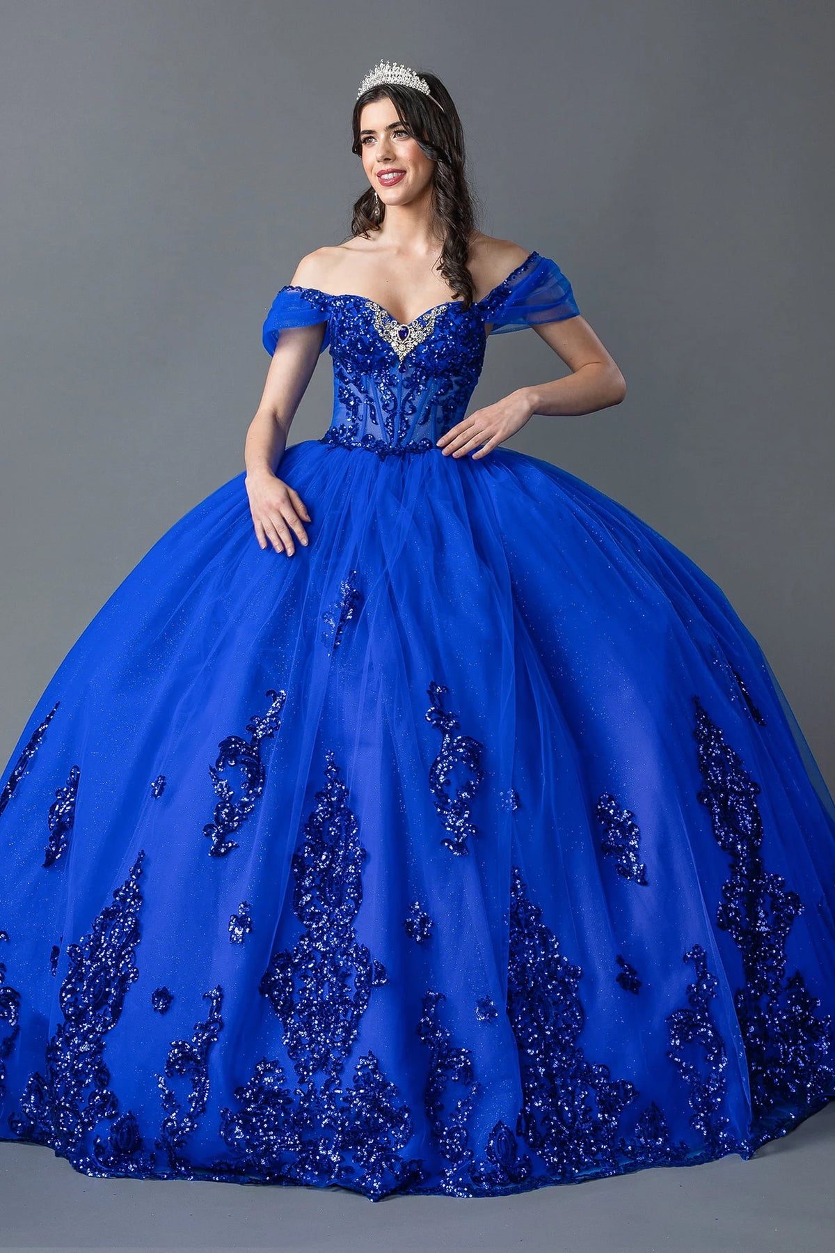 Showing beadwork on its sweetheart bodice and full skirt, this Royal Blue quinceañera ball gown is shown in full view.