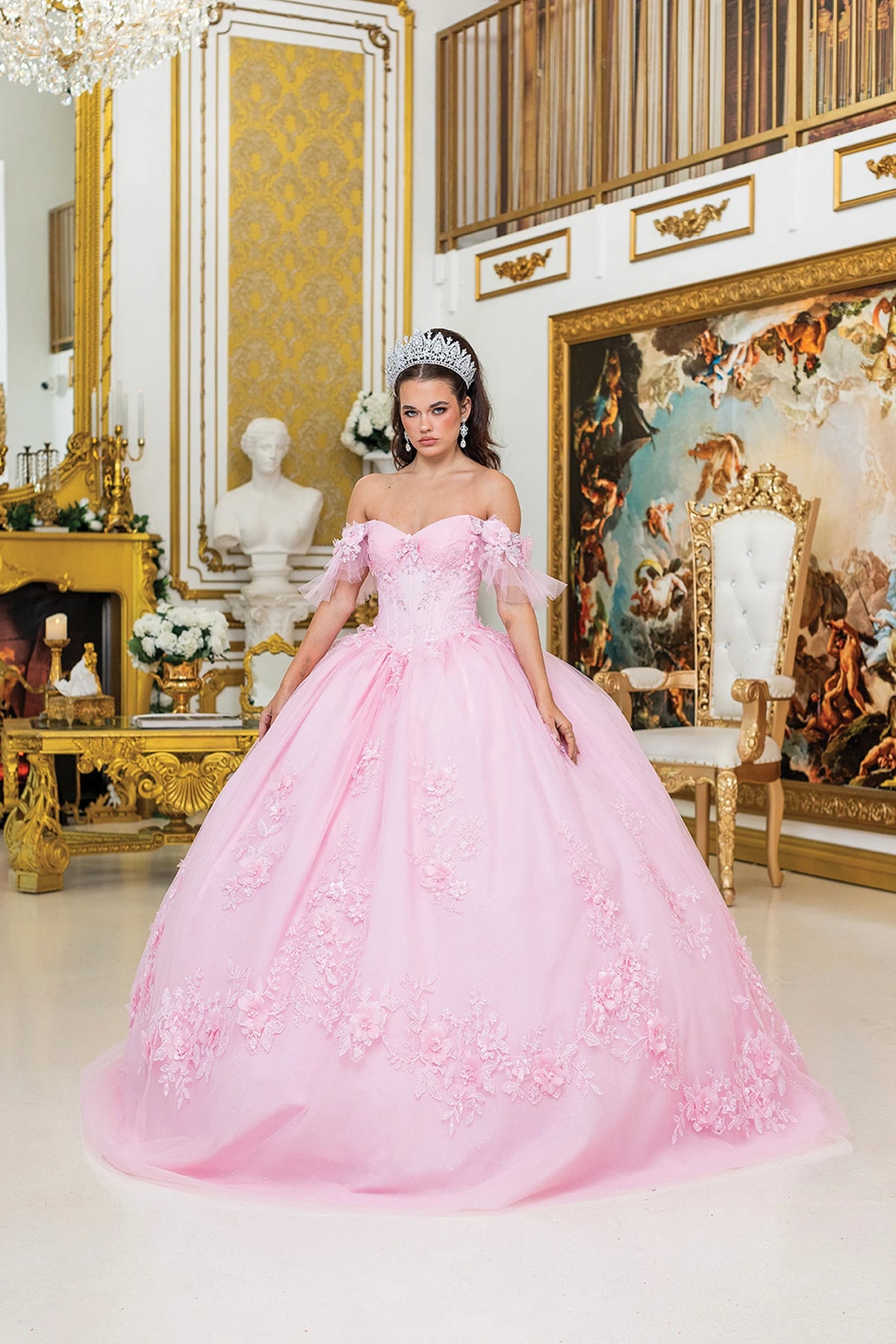 Front view of a Pink quinceañera gown with off-the-shoulder neckline, puff sleeves, and embroidered lace