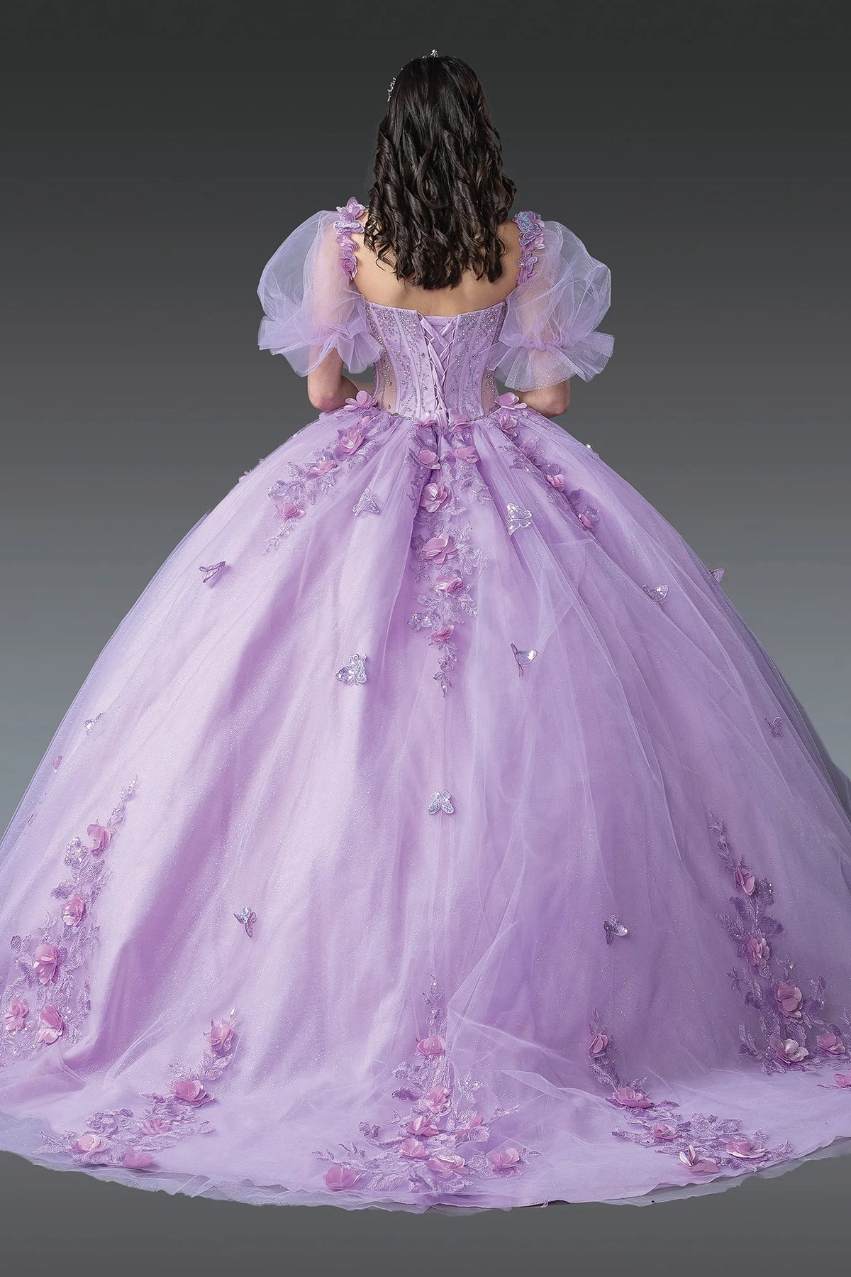 Back view of a Lilac quinceañera gown showing lace-up back, puff sleeves, and floral embroidery