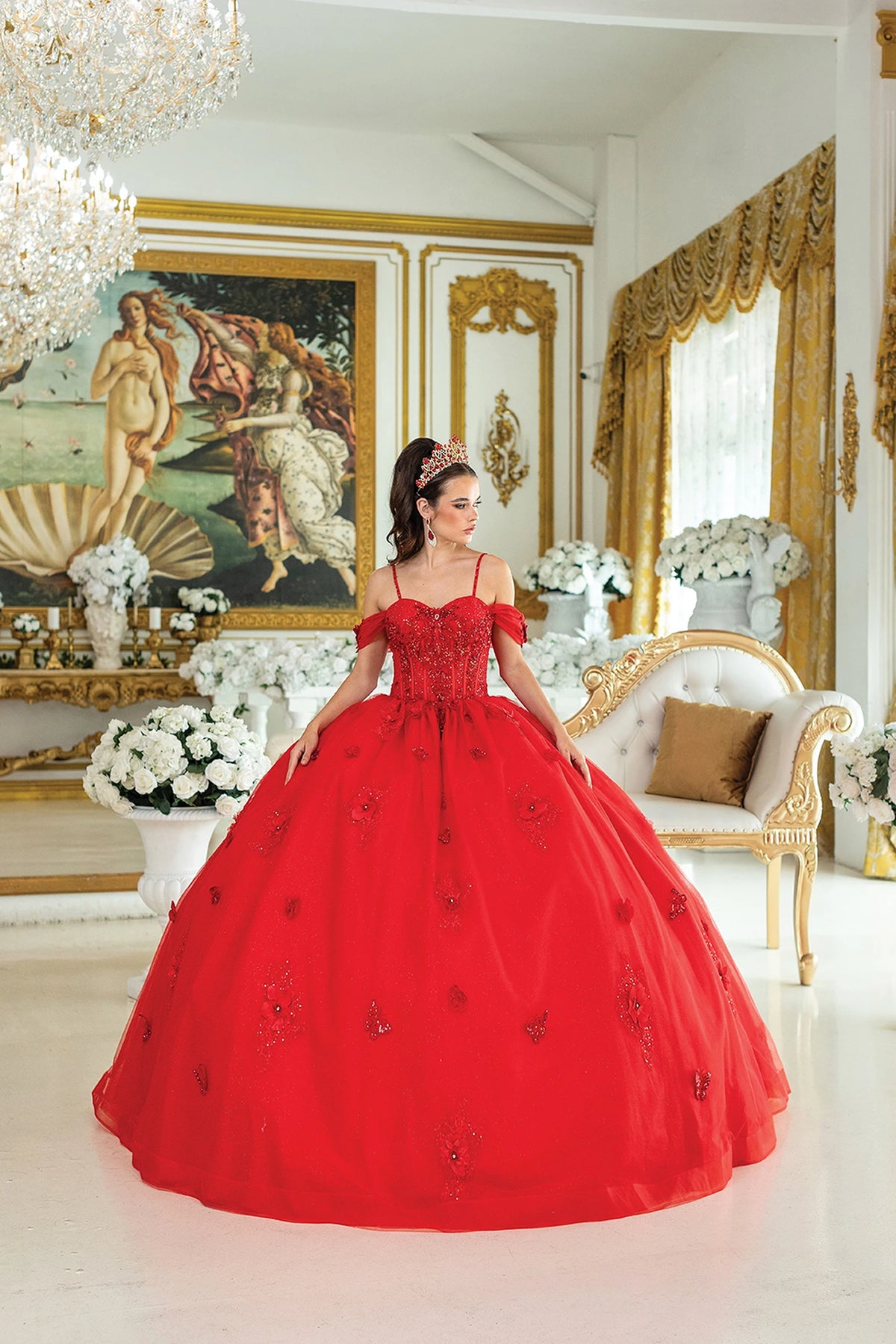 Showing floral appliqués scattered across its full tulle skirt, this Red quinceañera ball gown is shown in full view.