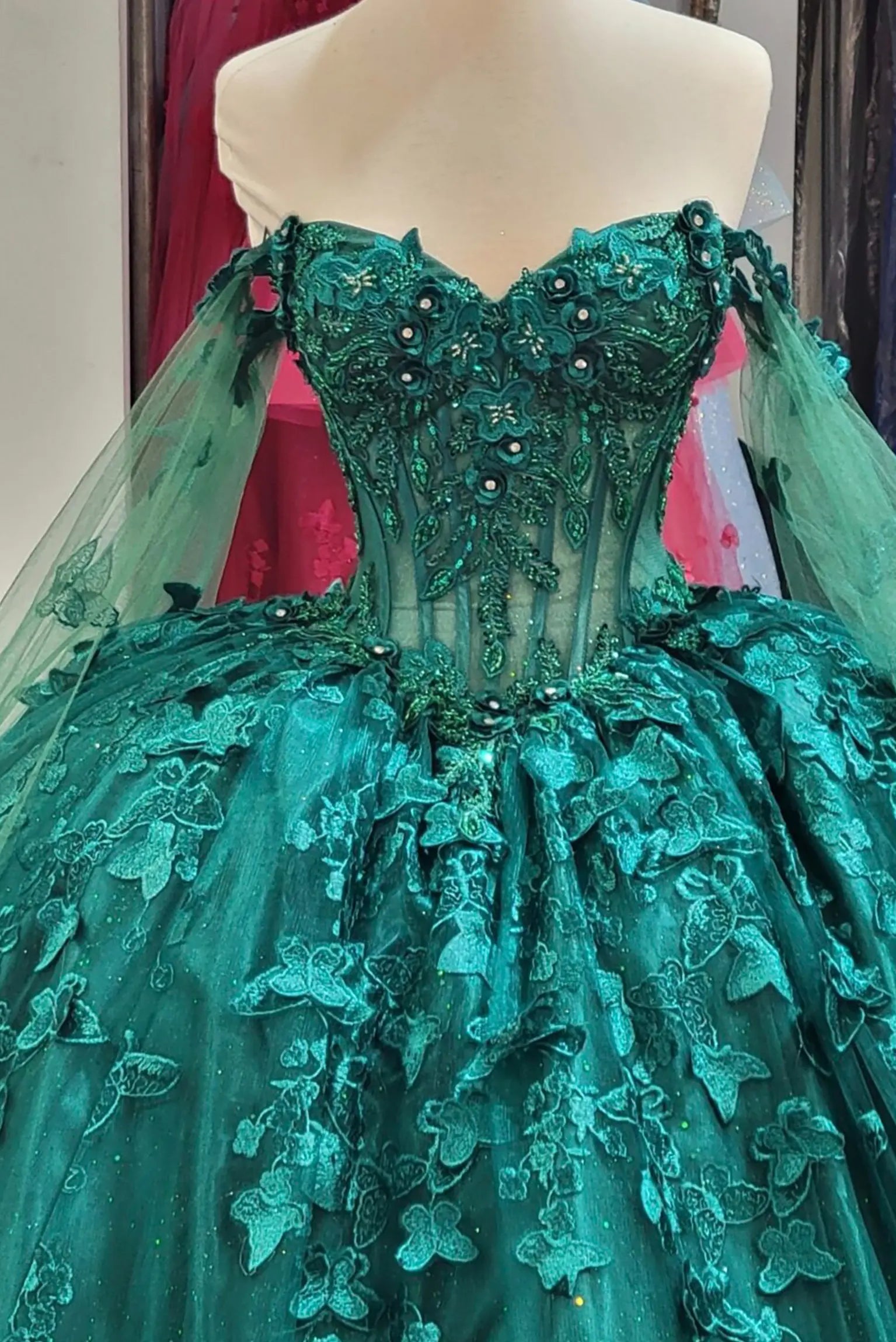 hunter green quinceanera dress with sweetheart neckline, floral embroidery, butterfly appliques