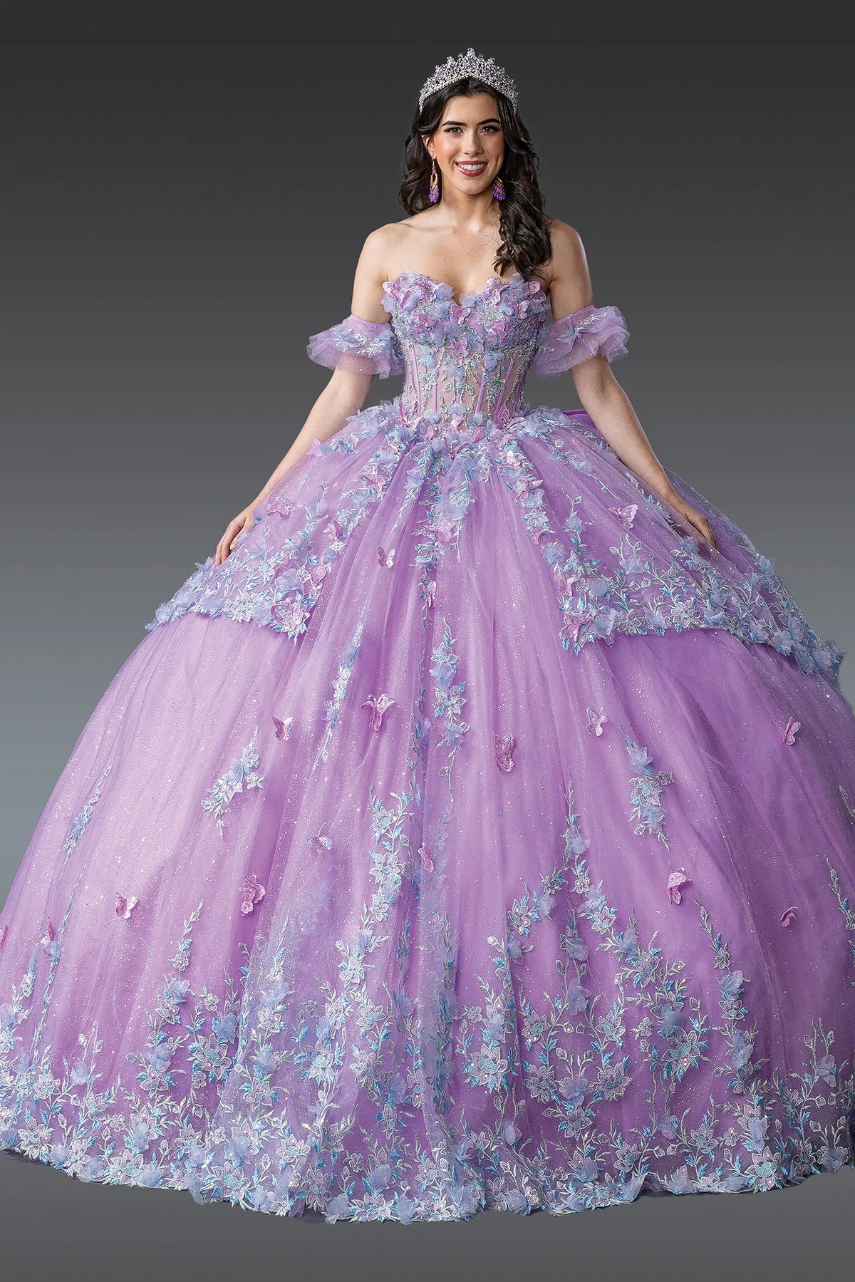 Front view of a Lilac quinceañera gown with strapless neckline, floral embroidery, and ruffled layered skirt