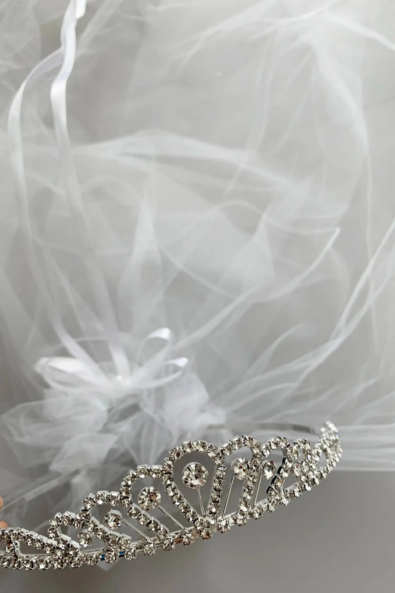 Silver and white rhinestone flower girl and first communion tiara and two-tier veil.