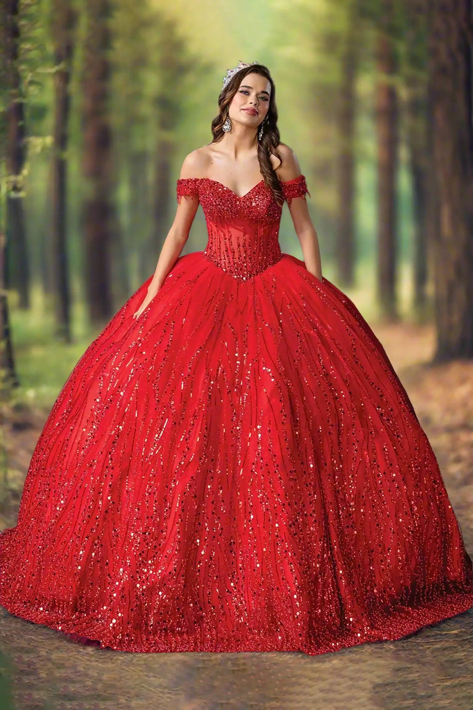 Woman standing front-facing in red quinceañera ball gown with off-shoulder sleeves, sequined overlay, beaded bodice, and voluminous sparkling skirt