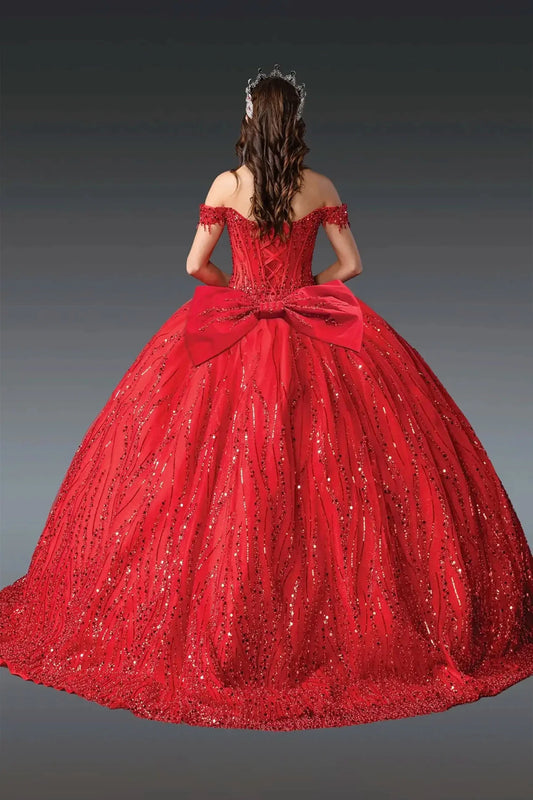 Woman standing back-facing in red quinceañera ball gown with off-shoulder sleeves, lace-up beaded bodice, sequined overlay, and flowing sparkling skirt with train