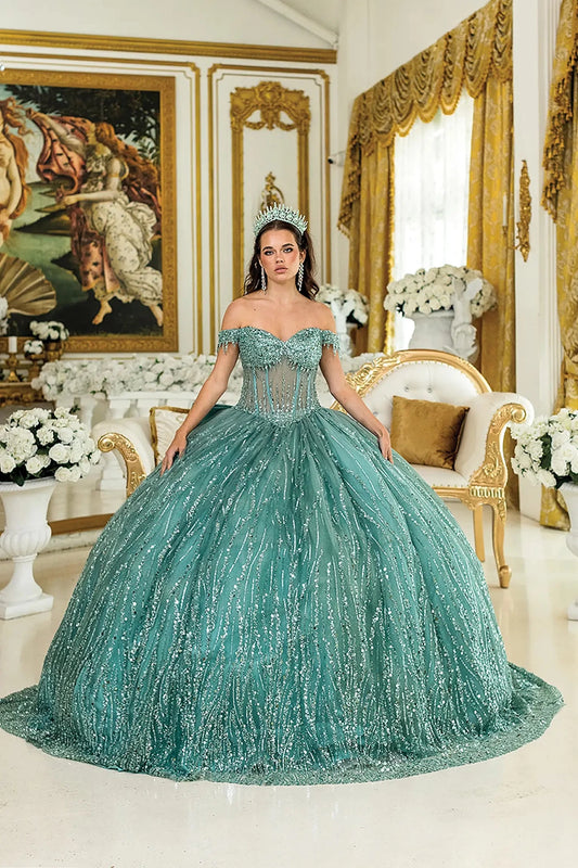 Woman standing front-facing in sage quinceañera ball gown with strapless bodice, embroidered floral accents, and layered ruffled voluminous skirt