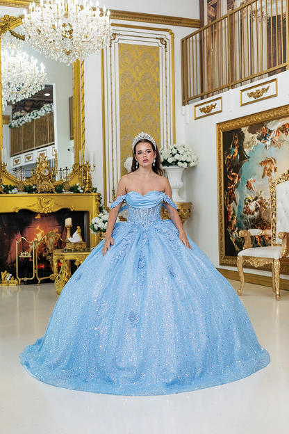 Front view of a woman wearing bahama blue quinceañera dress featuring off-shoulder neckline, ruched bodice, 3D floral appliqué, and glitter tulle skirt