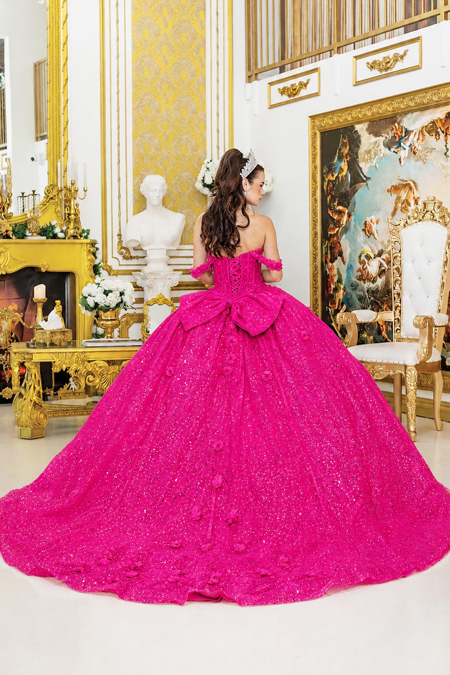 back of a fuchsia quinceañera dress featuring back bow and long train