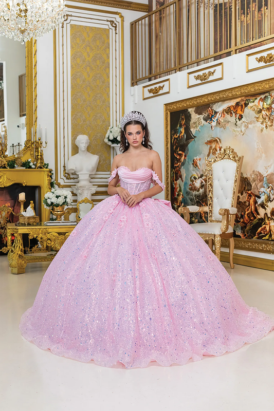 Front view of a woman wearing pink quinceañera dress featuring off-shoulder neckline, ruched bodice, 3D floral appliqué, and glitter tulle skirt