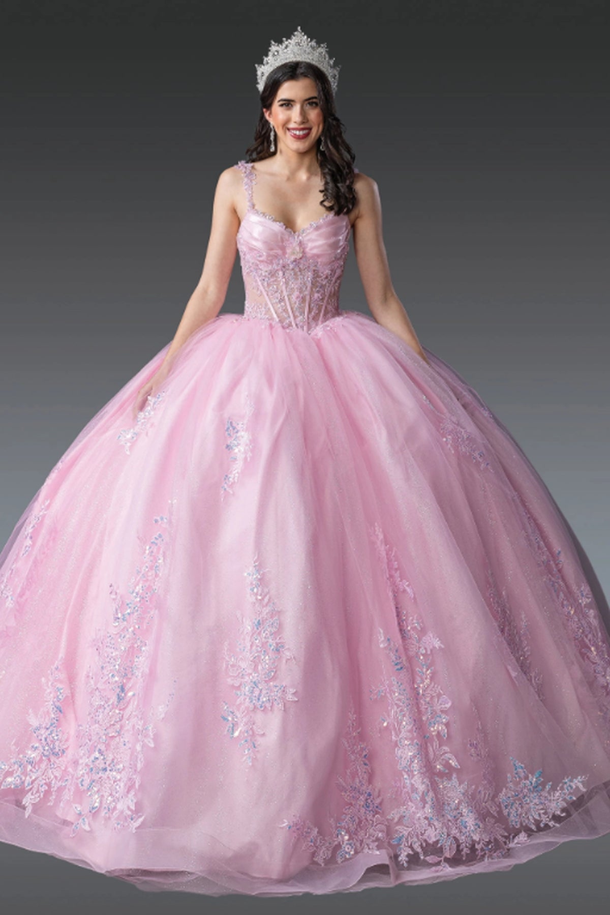 Front view of a Pink quinceañera gown with corset bodice and lace appliqués