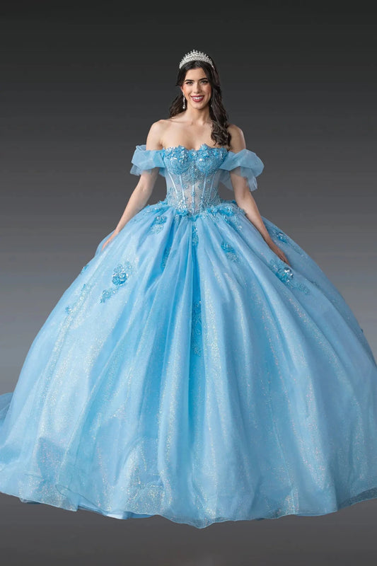 Woman standing front-facing in Bahama blue quinceañera ball gown with off-shoulder sleeves, beaded corset bodice, floral embellishments, and voluminous layered tulle skirt with glitter accents