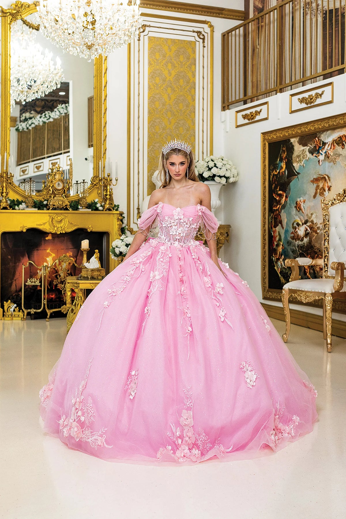 Front view of a Pink quinceañera gown with off-the-shoulder neckline, puff sleeves, embroidered corset bodice, and 3D floral appliqués