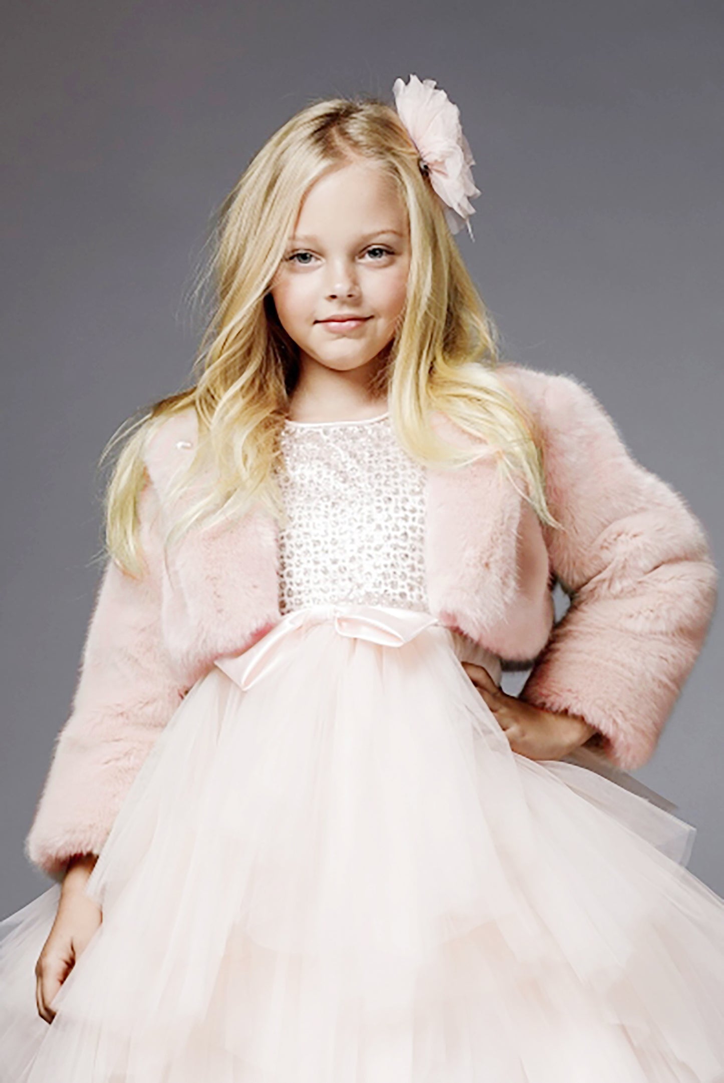 Blush Sweet Glamorous Soft Faux Fur Flower Girl Jacket Success - front view of girl wearing dress