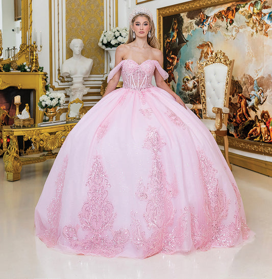 Woman in a pink ball gown standing in an ornate room with decorative elements.