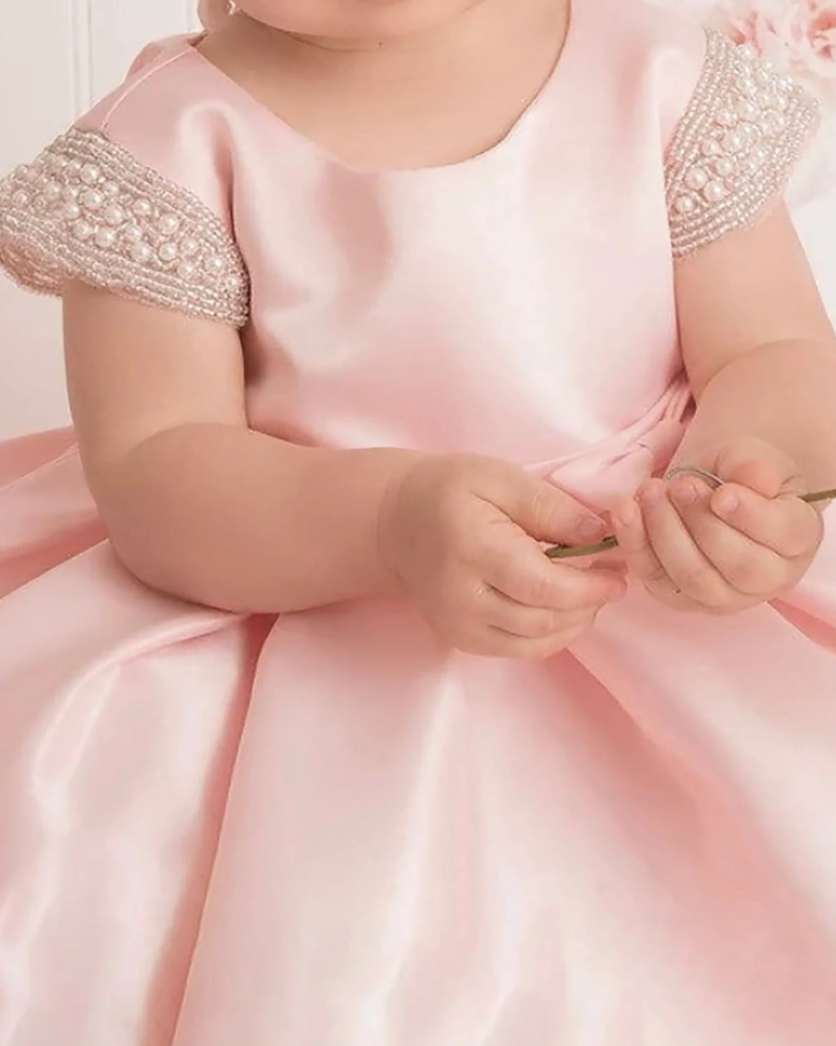 A pink flower girl dress with beaded shoulders.