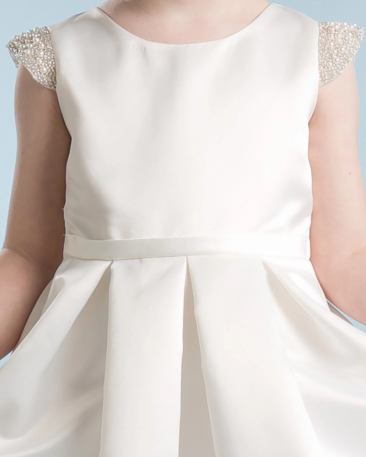White flower girl dress with embellished sleeves.