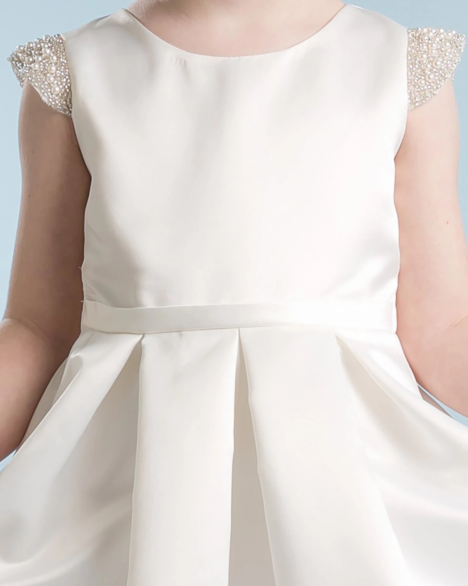 White flower girl dress with embellished sleeves.