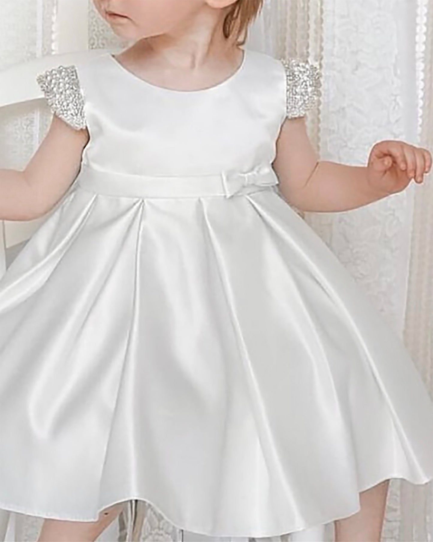 White satin flower girl dress with embellished sleeves. Also suitable as a communion dress. Also suitable as a baptism dress.